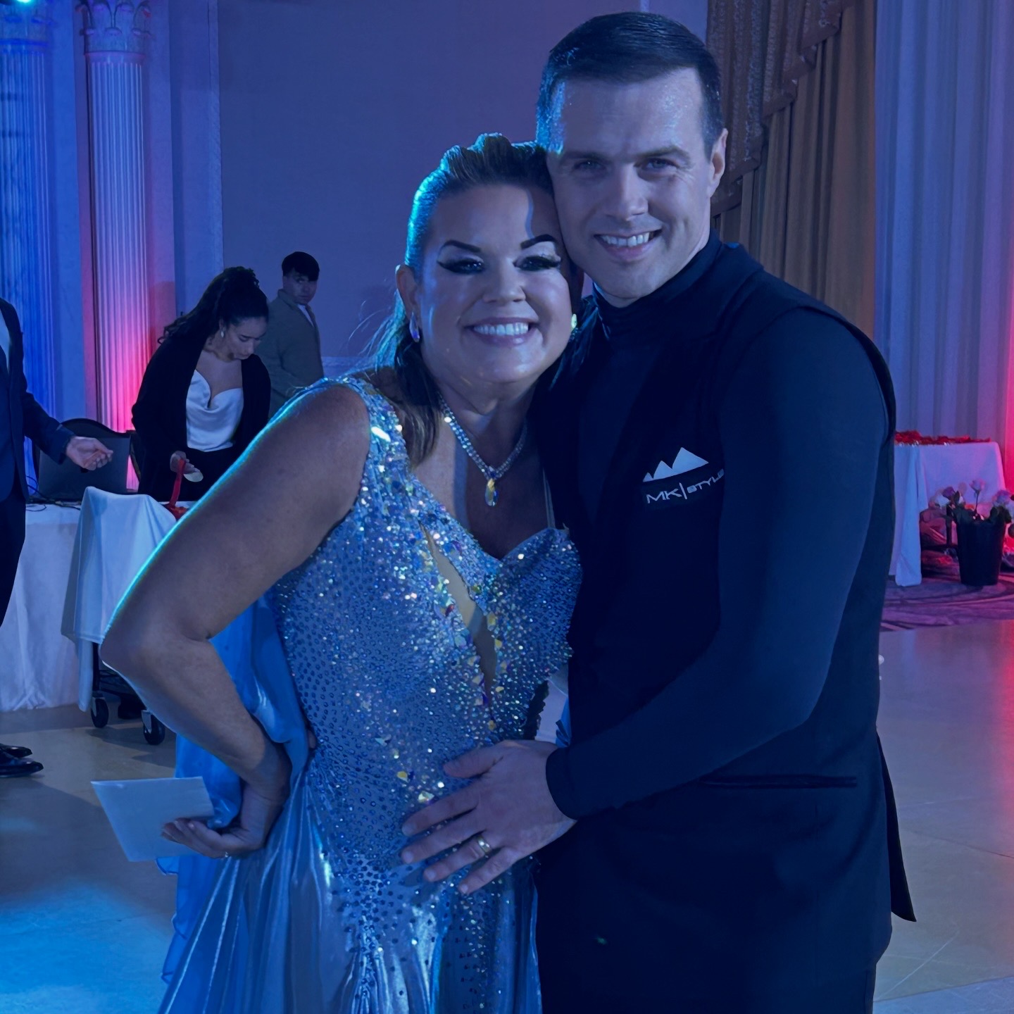 Student and instructor in blue ballroom gown
