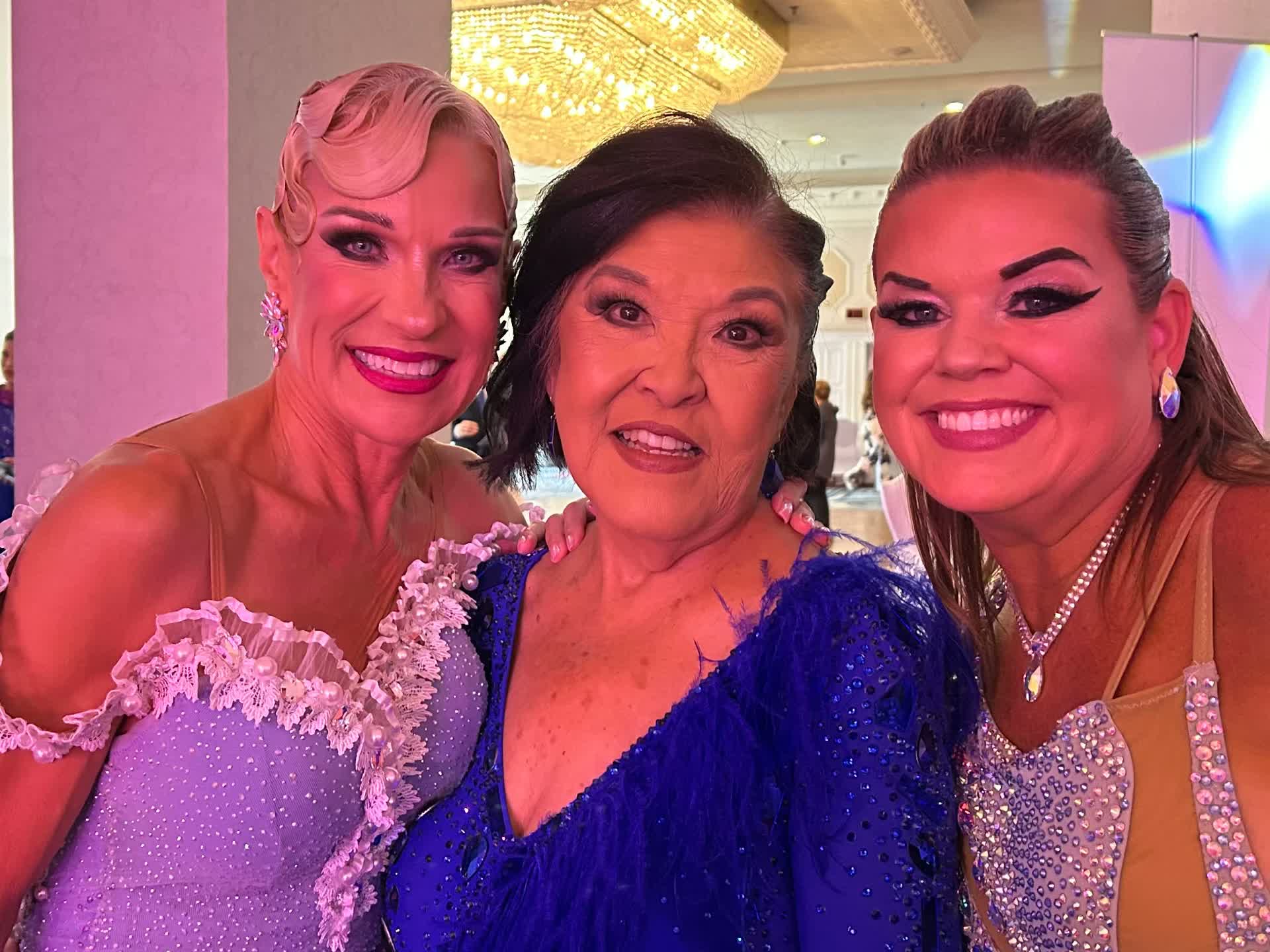 Three dancers backstage in costume